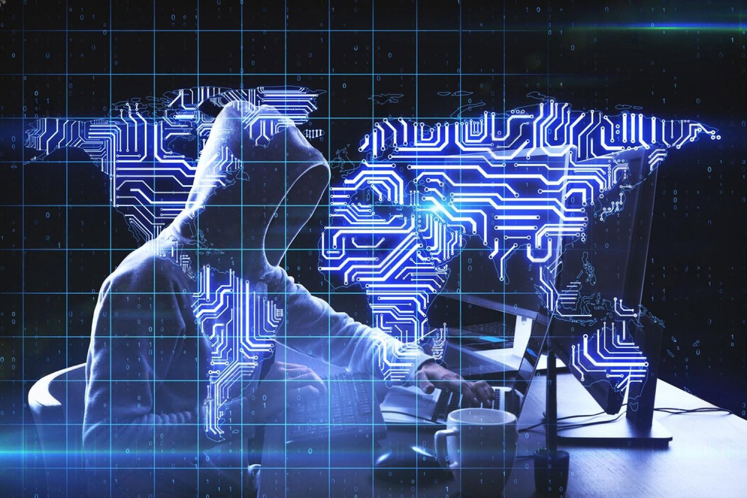 Hooded figure at a computer overlaid with a world map, representing data leak risks in UAE companies